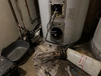 Replacement of the water heater element, under the open boiler lies a removed calcareous heater, in 2025, 53 dry heating elements replaced the wet heating element.