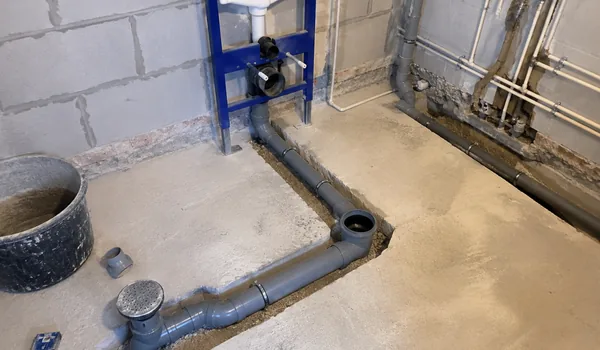 Sewage jobs, gray pipes are cut in the floor from the WC frame to the stairs, a soundproof pipe is installed in the wall of the living quarters.
